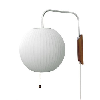 The Ball Wall Sconce is supported by a 2" thick solid walnut wall-mount